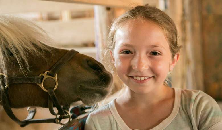 Young girl posing with a horse