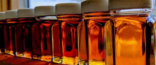 jars with different colored maple syrup