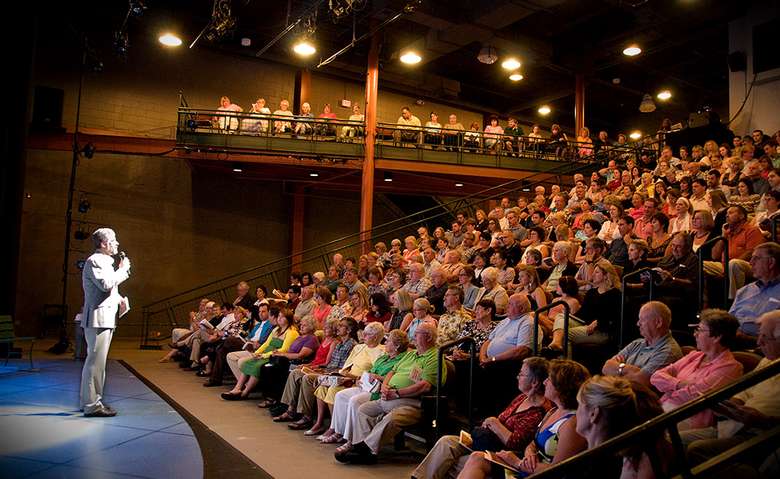 man speaking to a theater audience